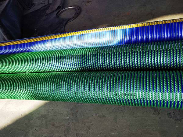 2 composite hoses with green nylon cover and 1 without on the floor