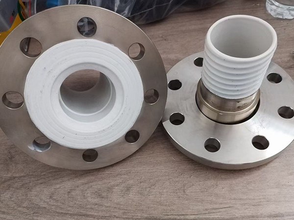 Two flange fittings on a wooden board.