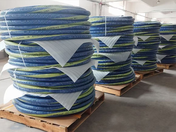 Sealed PTFE composite hoses with wooden board support.