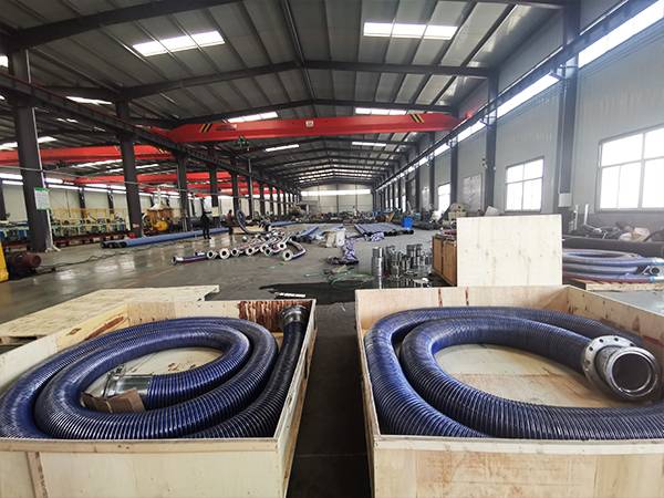 2 processed suction & discharge composite hoses are boxed in the workshop.