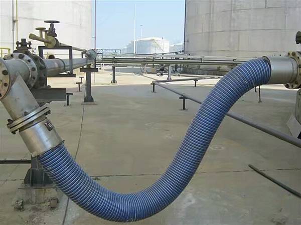 A blue tanker composite hose is installed on the pipe.